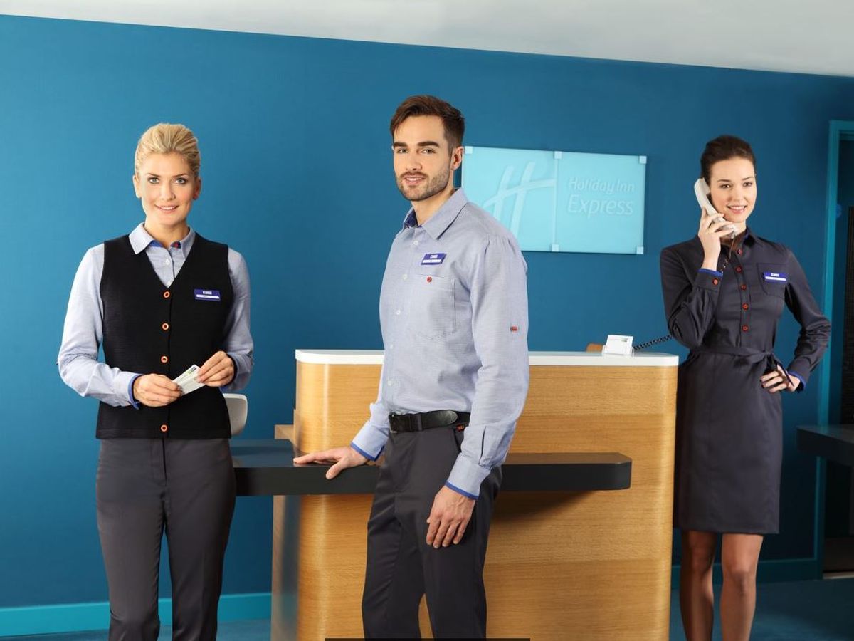 holiday inn express employee dress code Maryland,Silver Spring,Holiday Inn Express,hotel,front desk check in  reception reservation reservations register registration,Black woman female  women Stock Photo
