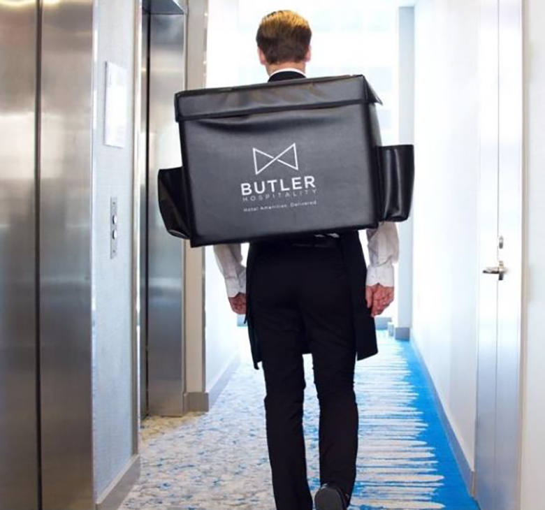 Exhibit 1: Butler Hospitality Employee Delivering Food — Photo by Northern Arizona University