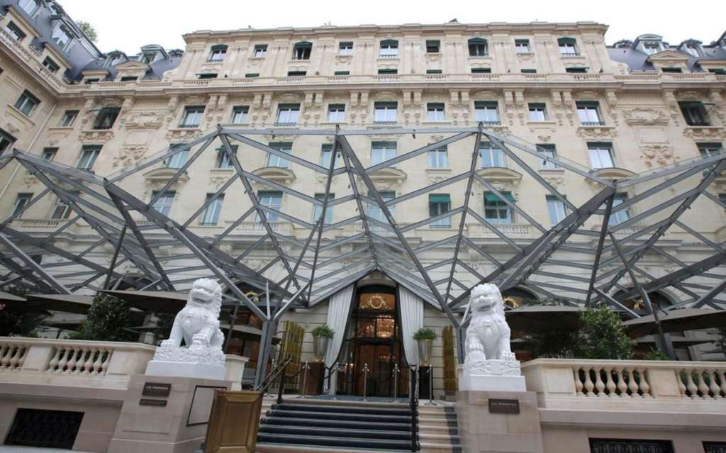 Lions outside the door of The Peninsula, Paris— Photo by Copyright Suzanne Godfrey