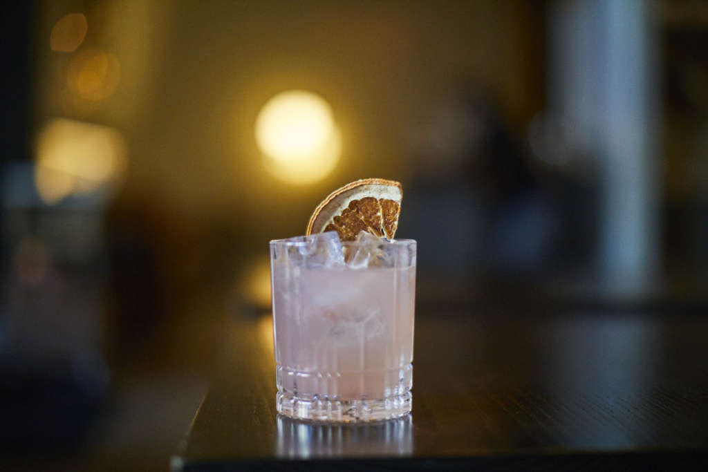 Expect to see more drinks with dehydrated garnishes as bars work to reduce waste. Pictured: Cocktail from Henley at Kimpton Aertson in Nashville, Tenn. Photo Courtesy: Emily Hall— Photo by IHG