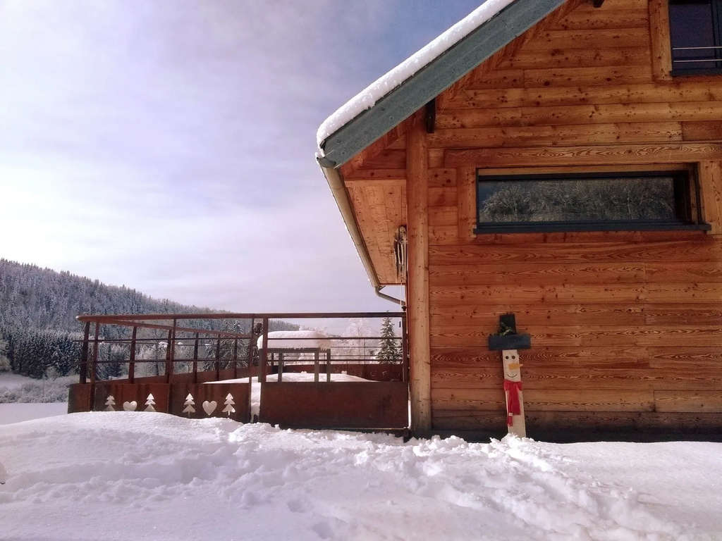 This chalet in Entre-Deux-Monts, France has plenty of room for a tree, and a cheery snowman to greet you during a wintery stay. — Source: Airbnb