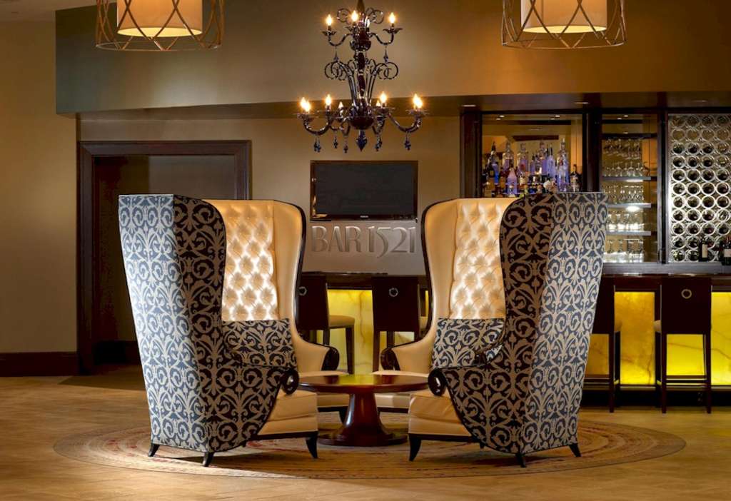 Four splurge-worthy wingback chairs at the Wyndham Grand Orlando Resort at Bonnet Creek make a bold statement— Source: Baskervill