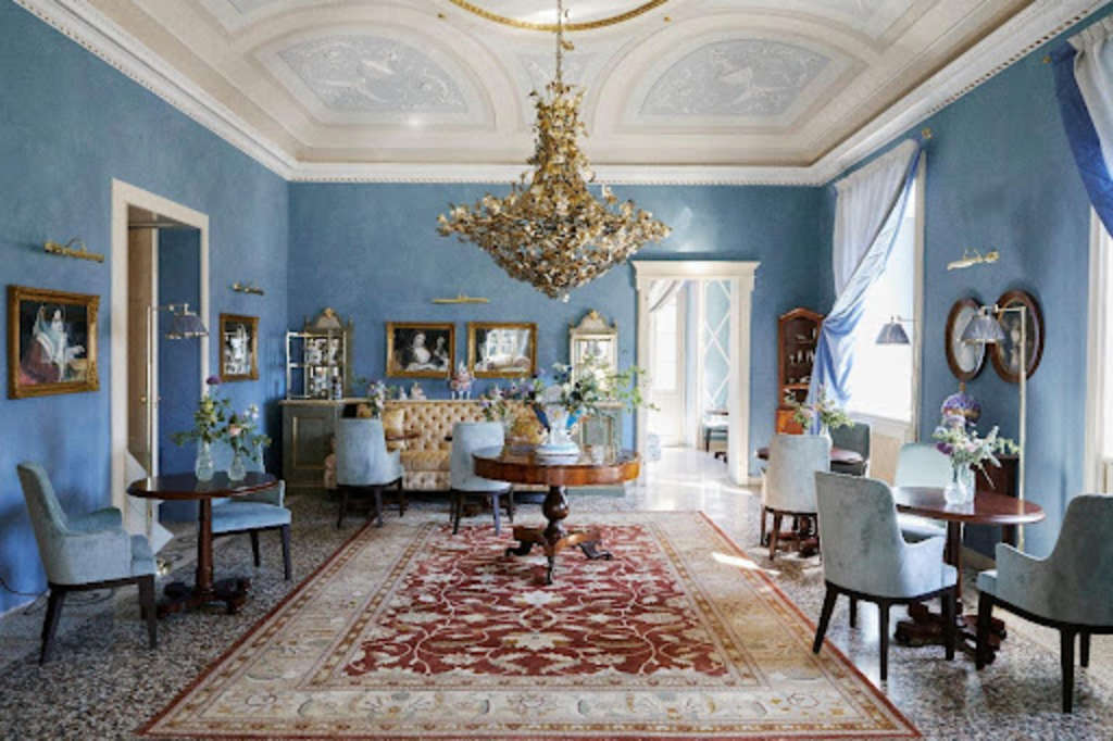 Sala delle Dame with its beautifully appointed furnishings, antiques and arts in a complementary color palette of sky blues, off-whites and ochre— Source: Stefan Giftthaler